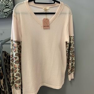 NWT. Long sleeve, cream color with leopard print detail. Size small